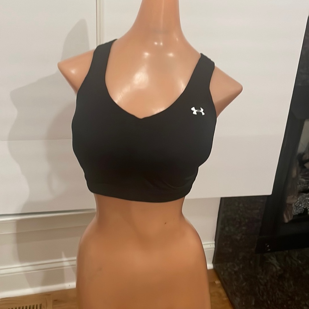 NEVER WORN UNDER ARMOUR black sports bra w/ build in cups. Size large
